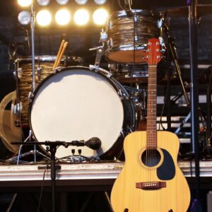 Acoustic guitar and drum set on stage